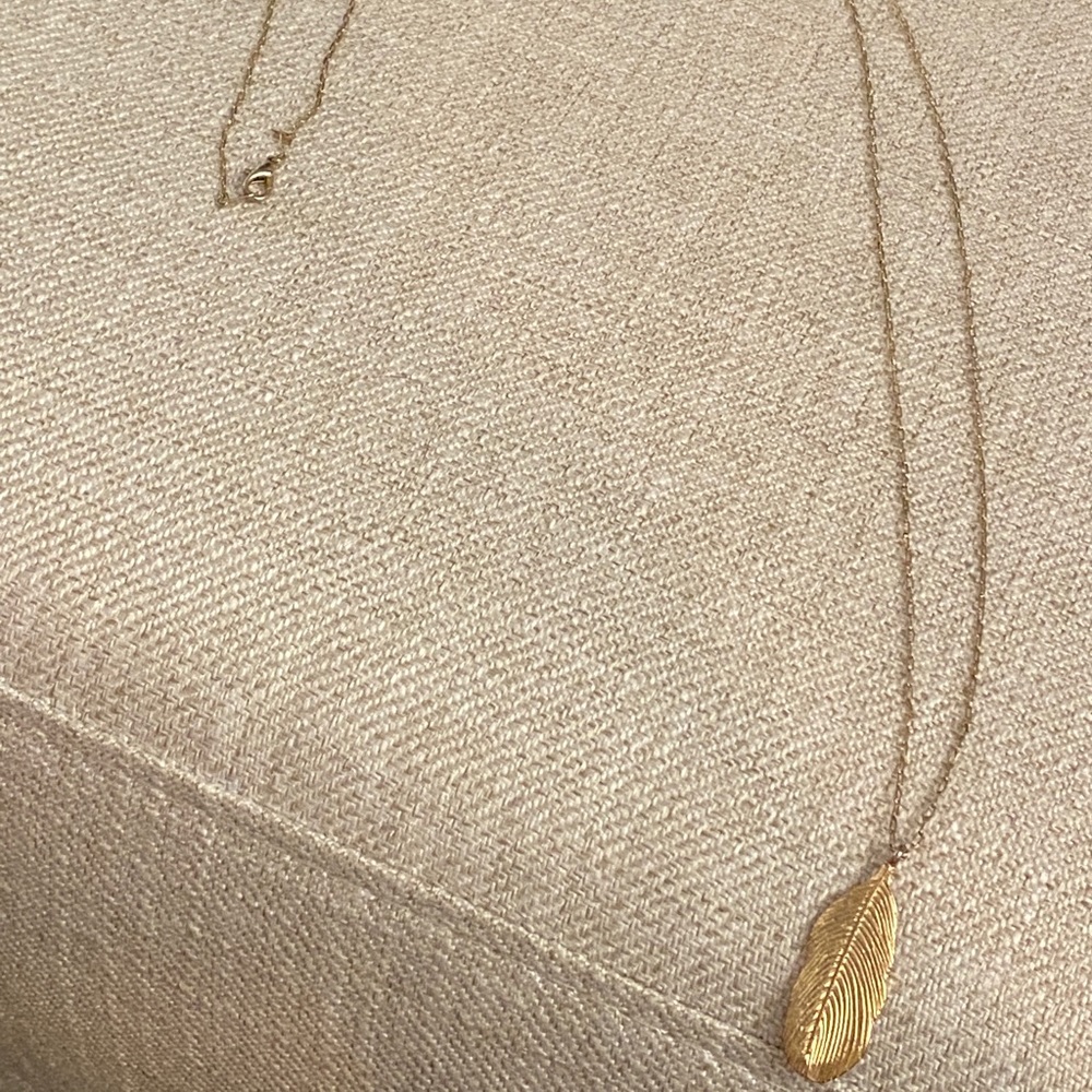 Long gold feather pendant necklace